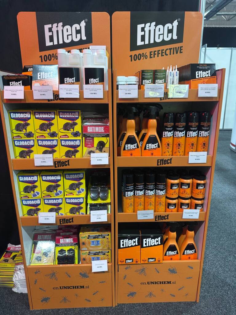 Retail display of Effect brand pest control products on orange shelves, including Glodacid boxes, Ratmor, spray bottles, and aerosols.
